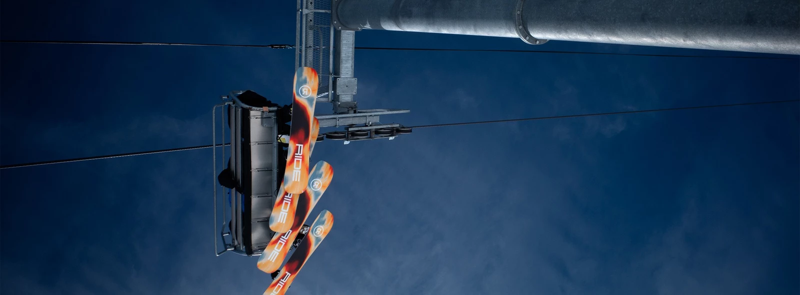 Detail from RIDE 2027 snowboard range artwork in blue and orange